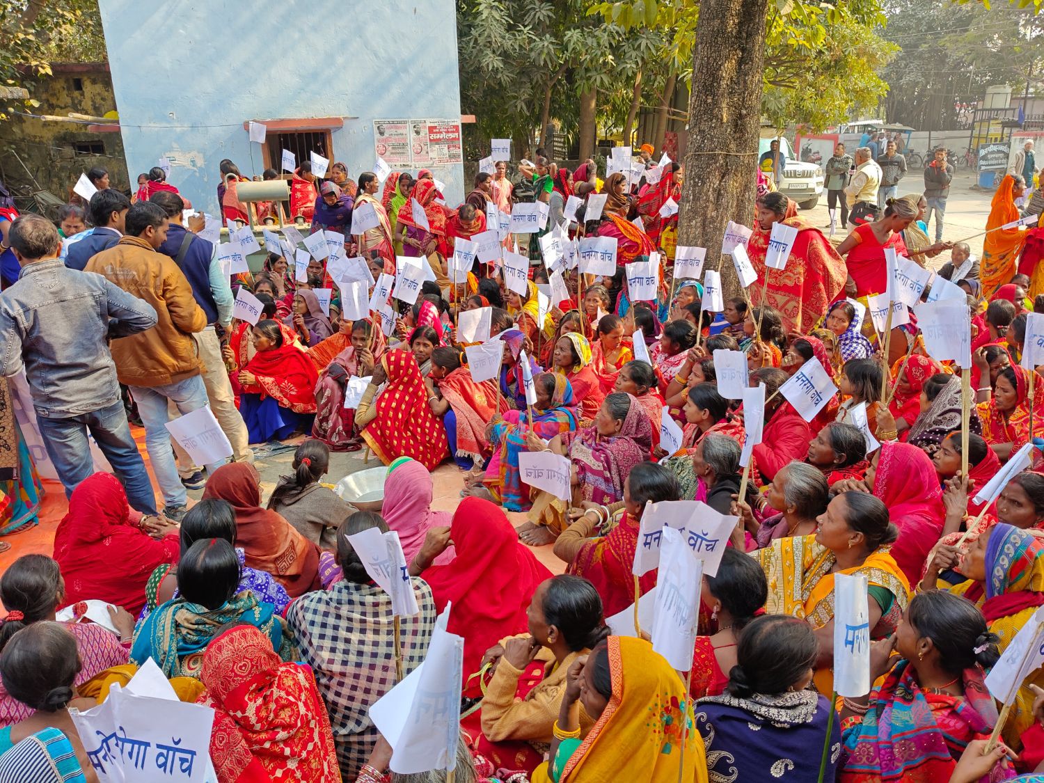 Villagers gathered at a public meeting in Bihar, holding placards