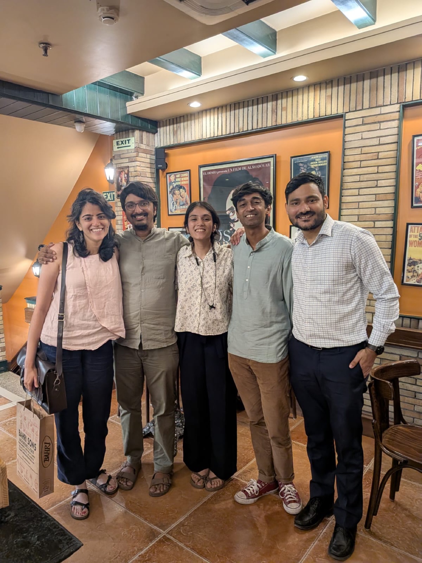 Five GRAMA team members posing together at a restaurant