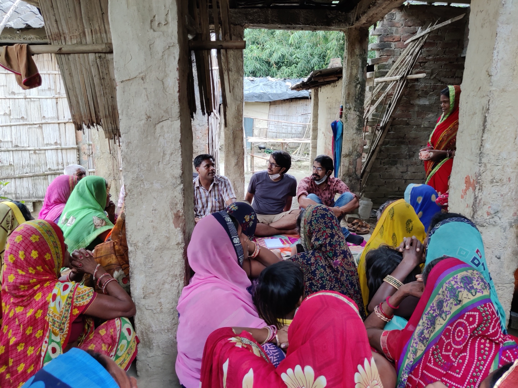 GRAMA team in a group discussion with women in a village courtyard